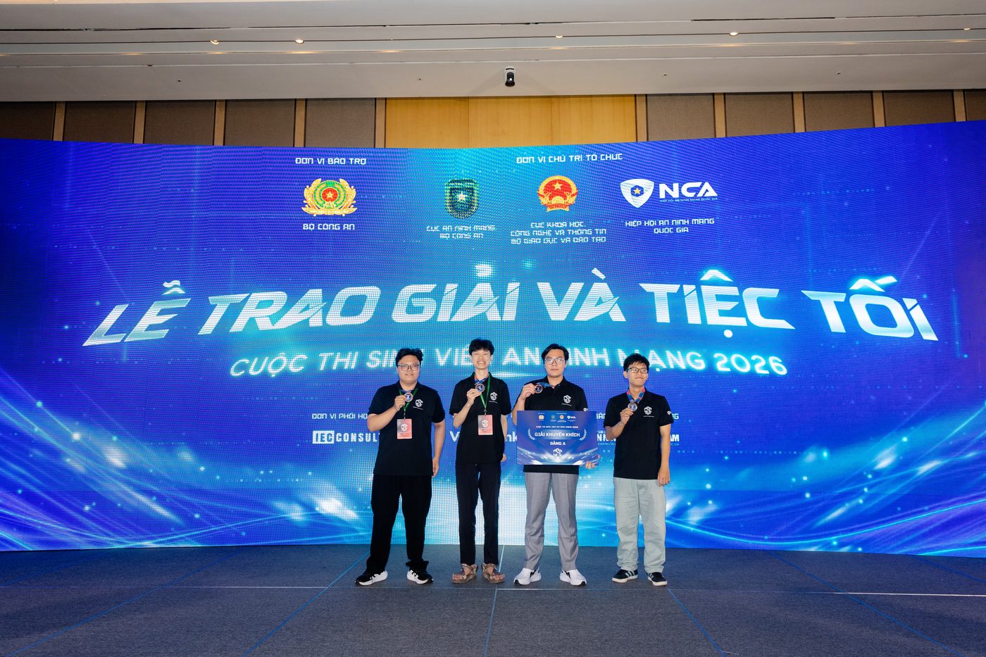 The four-person team on stage at the Cybersecurity Student Contest 2026 award ceremony, holding the Category A Consolation Prize board